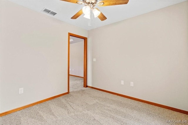 carpeted spare room featuring ceiling fan