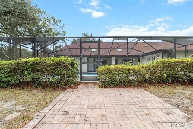 back of house featuring a lanai