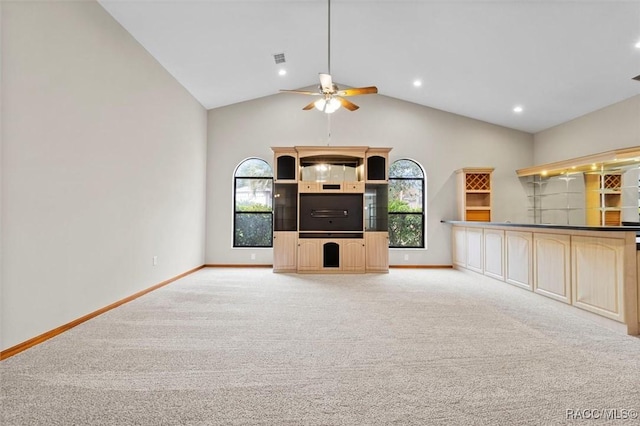 unfurnished living room with ceiling fan, light colored carpet, and lofted ceiling