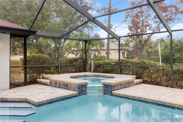 view of swimming pool featuring glass enclosure and an in ground hot tub