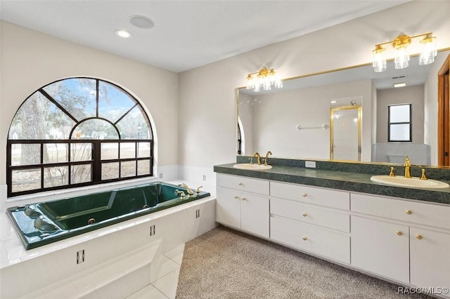 bathroom with tile patterned floors, vanity, and independent shower and bath