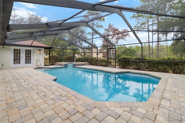 view of pool with an in ground hot tub, french doors, a patio area, and a lanai