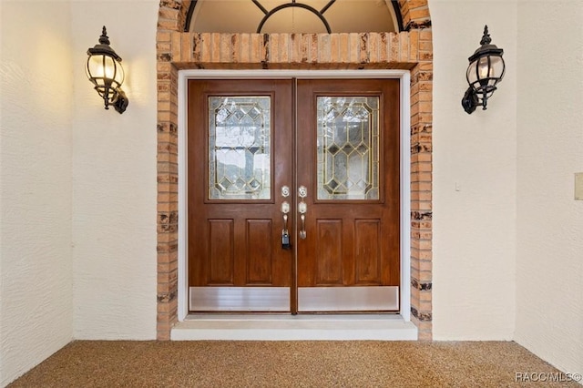 view of exterior entry featuring french doors