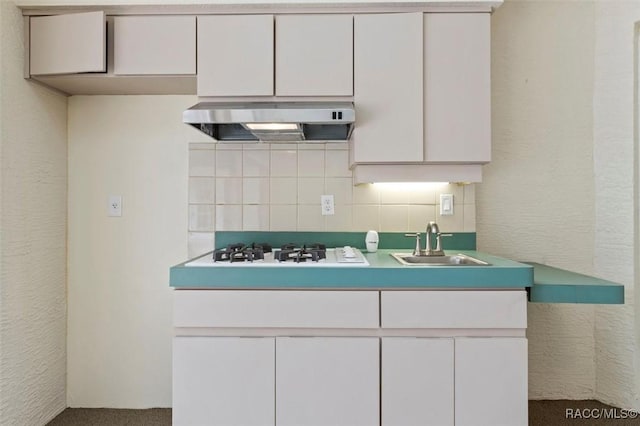 kitchen featuring white cabinets and range hood