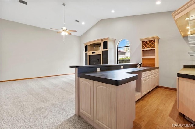 kitchen featuring light carpet, high vaulted ceiling, sink, ceiling fan, and light brown cabinetry