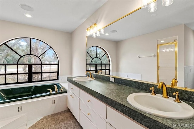 bathroom featuring vanity and independent shower and bath