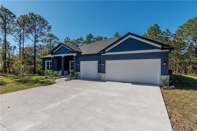 view of front of house featuring a garage and a front lawn