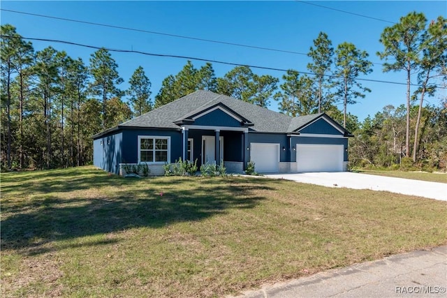 view of front of property with a garage and a front lawn