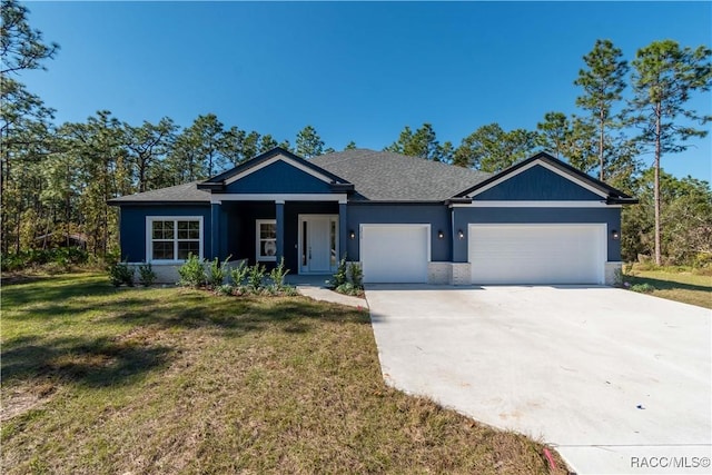 view of front of house featuring a garage and a front lawn