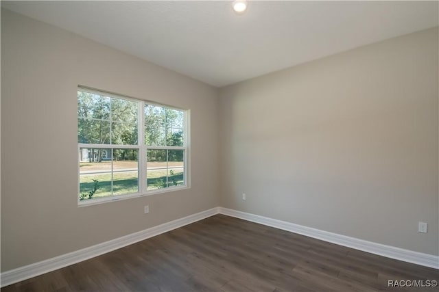 spare room featuring dark wood-type flooring