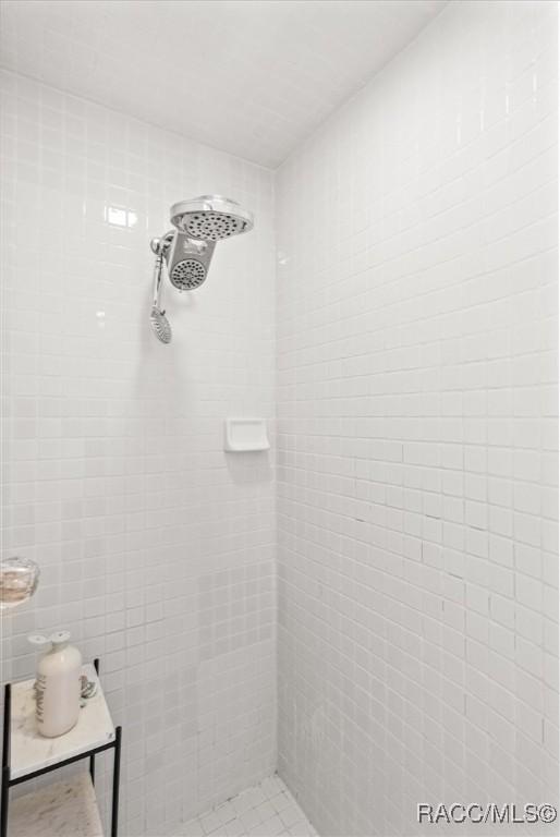 bathroom with tiled shower