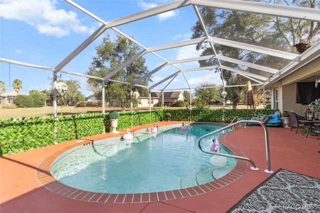 view of swimming pool featuring glass enclosure and a patio