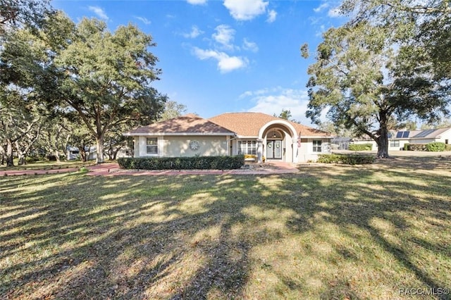 view of front of house featuring stucco siding and a front lawn