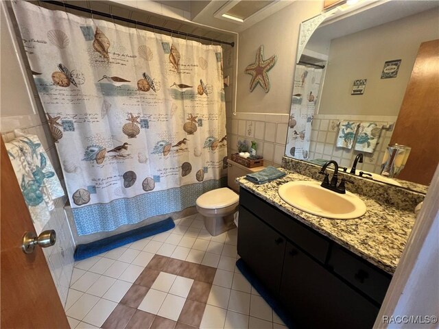 3809 N Seminole Pt, Crystal River, FL 34428 - bathroom with tile walls, tile patterned flooring, vanity, toilet, and a shower with curtain