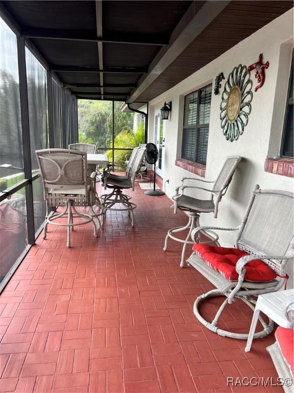 3809 N Seminole Pt, Crystal River, FL 34428 - sunroom / solarium featuring outdoor dining area and beamed ceiling