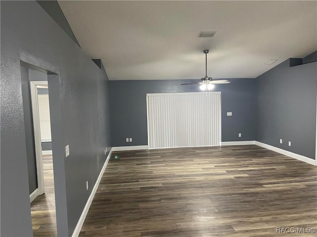 spare room with dark wood-type flooring and ceiling fan