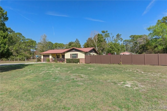 view of yard featuring a garage and fence