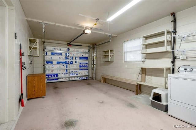 garage with washer / dryer and a garage door opener