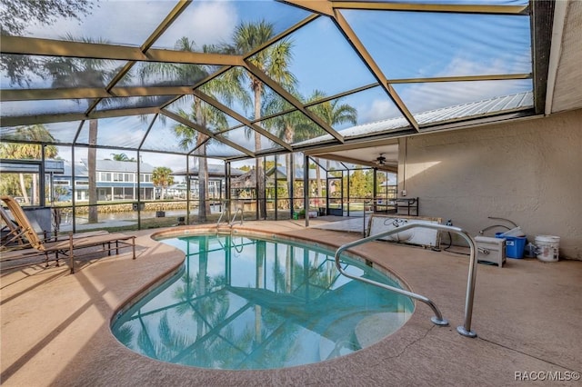 pool featuring a lanai and a patio area