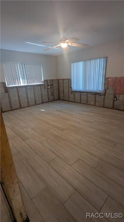 unfurnished room featuring ceiling fan and light wood-style flooring