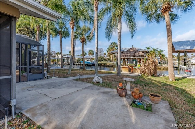 view of patio / terrace with a water view and a gazebo