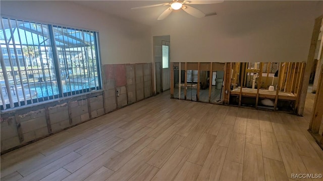 interior space with light wood-type flooring and a ceiling fan