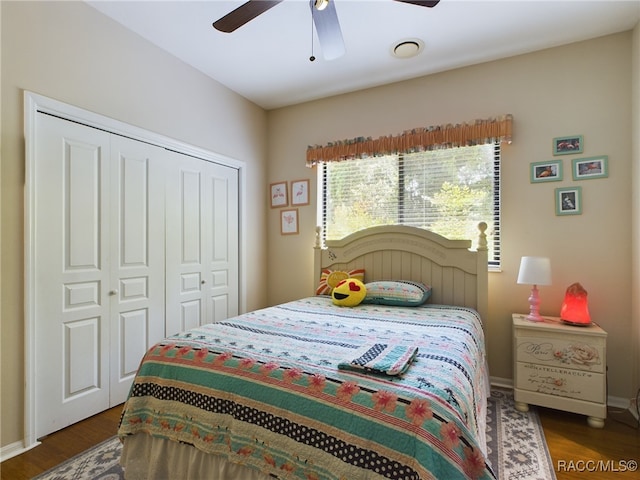 bedroom featuring a closet, dark wood-type flooring, and ceiling fan