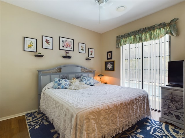 bedroom featuring access to exterior and wood-type flooring