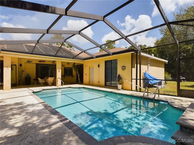 view of pool featuring a lanai, ceiling fan, and a patio area