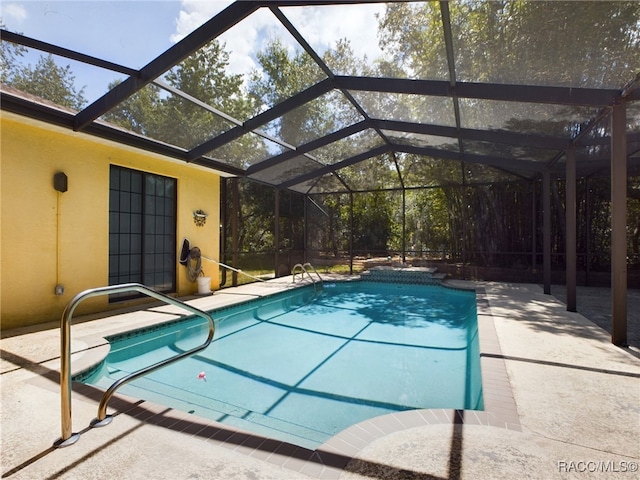 view of pool featuring a lanai and a patio area