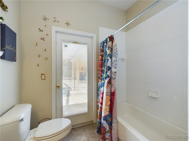 bathroom with shower / bath combo and toilet