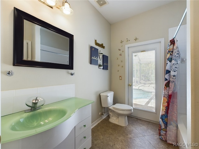 full bathroom featuring shower / tub combo, vanity, toilet, and tile patterned floors