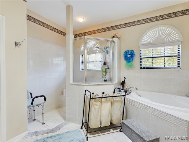 bathroom featuring tile patterned flooring and shower with separate bathtub