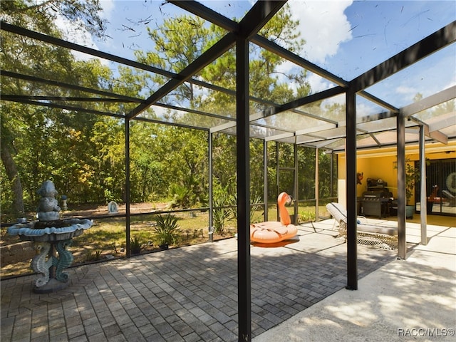 view of patio / terrace with a lanai