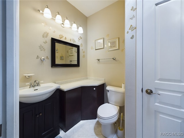 bathroom with tile patterned flooring, vanity, and toilet