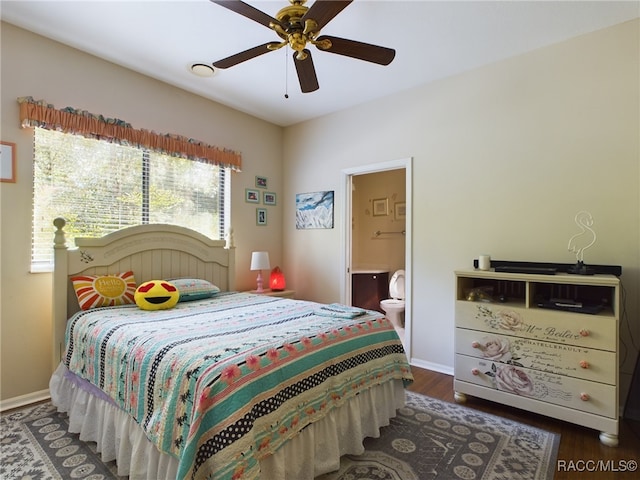 bedroom featuring dark hardwood / wood-style flooring, ensuite bathroom, and ceiling fan