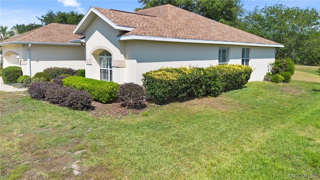 view of property exterior with a lawn