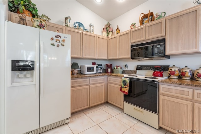 kitchen with vaulted ceiling, light brown cabinetry, light tile patterned floors, and white appliances