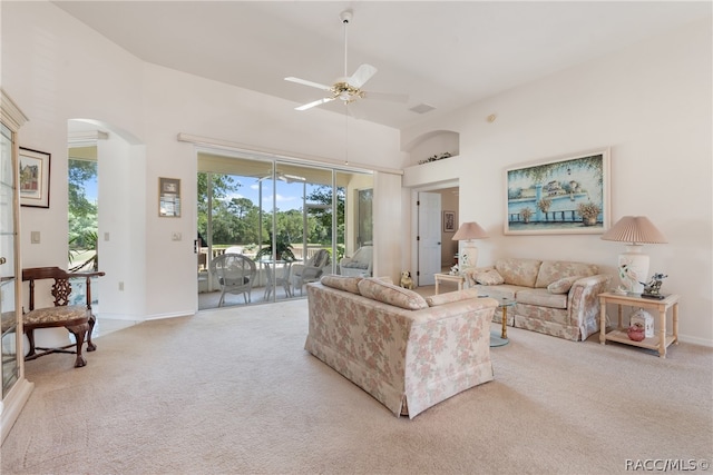 living room with ceiling fan and light colored carpet