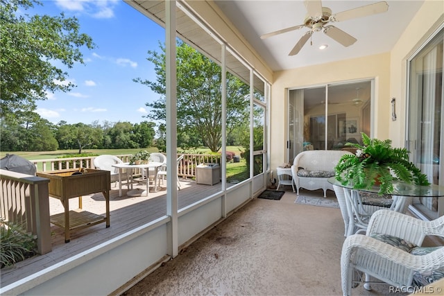 sunroom / solarium featuring ceiling fan