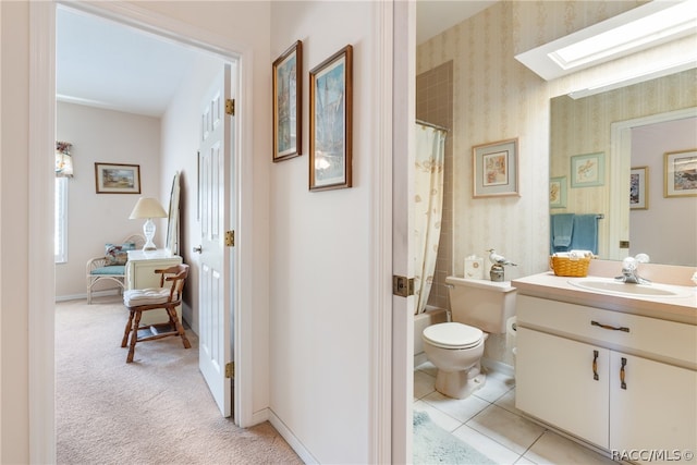 full bathroom with vanity, tile patterned floors, a skylight, toilet, and shower / tub combo with curtain