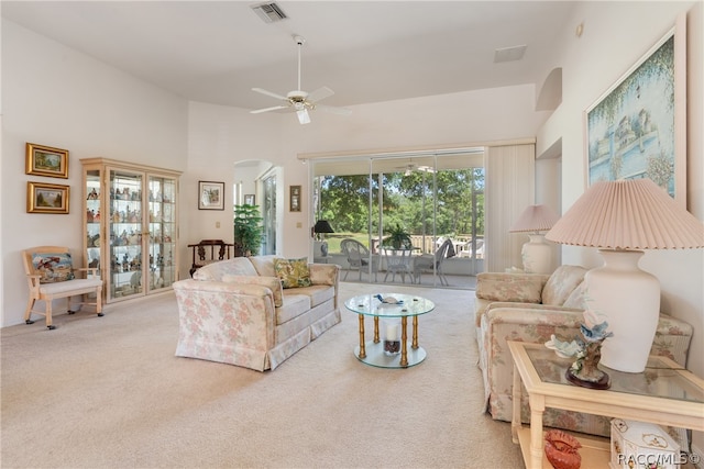 carpeted living room featuring ceiling fan