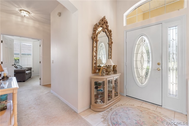 foyer entrance with light colored carpet