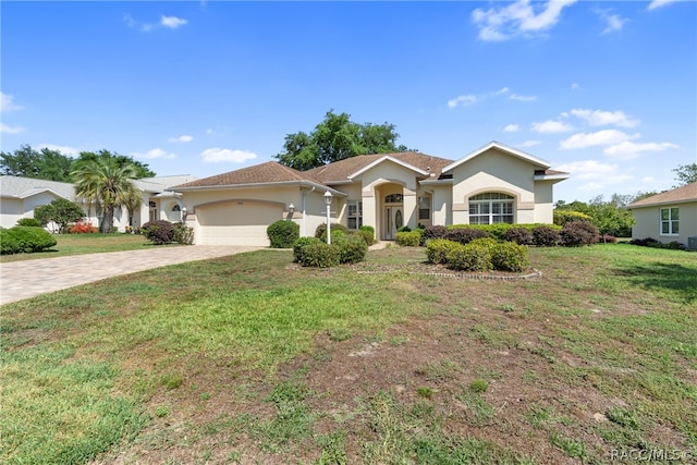 view of front of property featuring a garage and a front yard