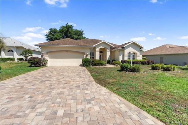 ranch-style home with a garage and a front yard