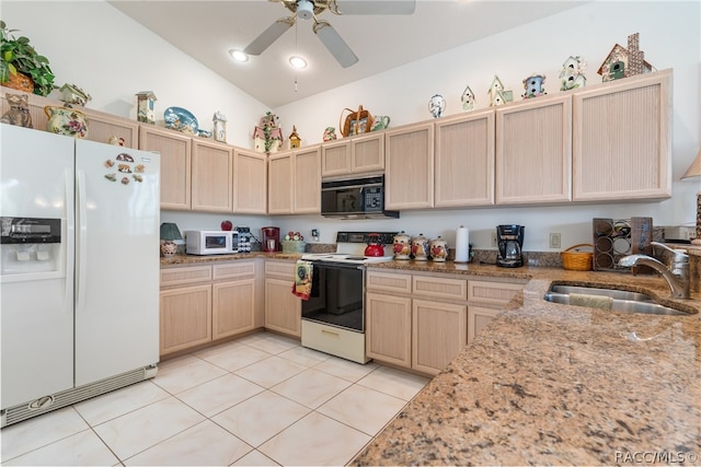 kitchen featuring sink, light brown cabinets, lofted ceiling, white appliances, and light tile patterned floors