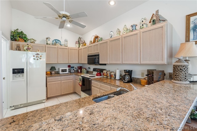 kitchen with lofted ceiling, sink, white appliances, and kitchen peninsula