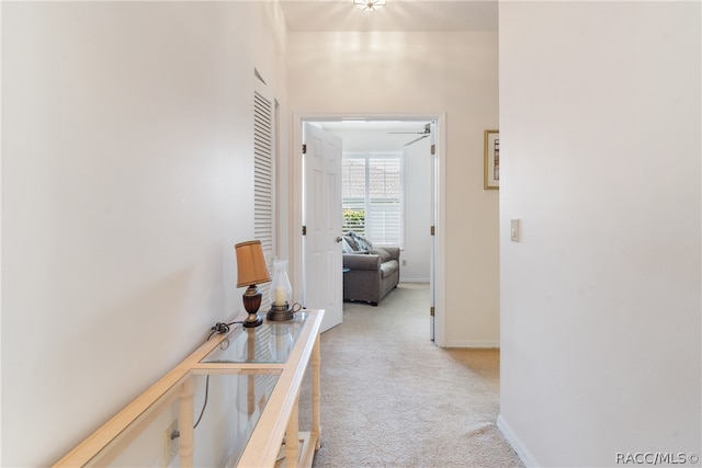 hallway featuring light carpet