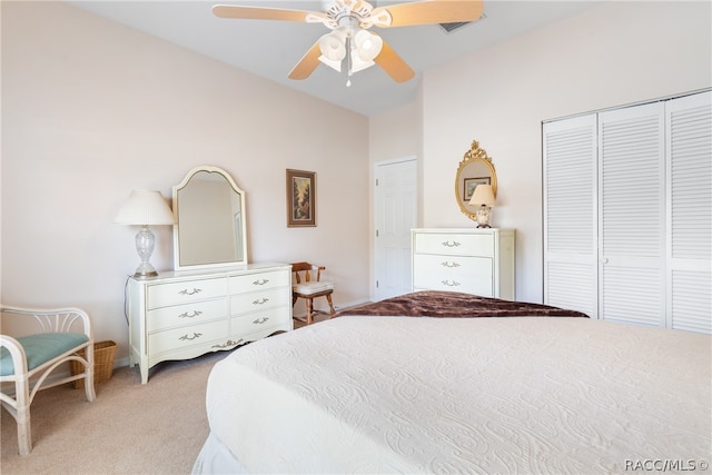 carpeted bedroom featuring ceiling fan and a closet