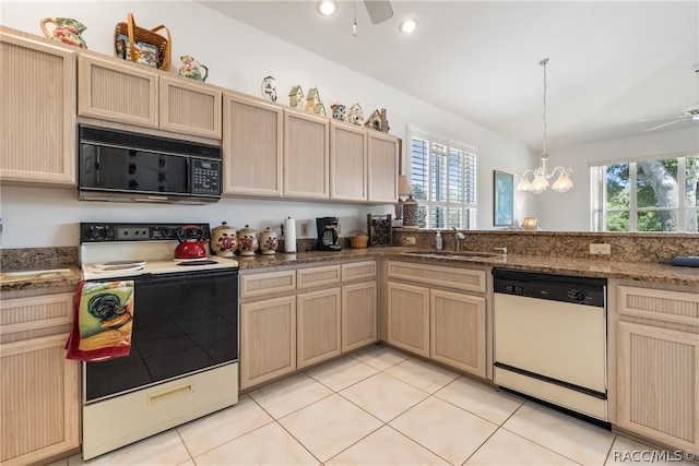 kitchen featuring light tile patterned flooring, white appliances, a healthy amount of sunlight, and sink